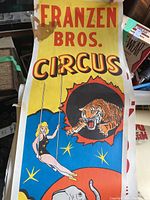 Franzen Bros Circus poster featuring a female trapeze artist, tiger, and elephant on a bright yellow, red, and blue background.