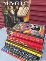 Books arranged stacked with focus on spines to show titles and authors.