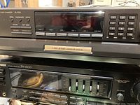 Front view showing Technics 5 disc changer on top and Pioneer SX-1300 receiver below with control panel and graphic equalizer sliders visible.