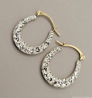 Front view of earrings showing side with clear cubic zirconia stones set in 10K gold loops