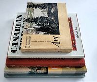 Stack of four Canadian art books showing varied cover designs and colors.