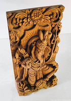 Front view of the hand carved teak Ganesh wall plaque, showing detailed figure and ornamental border.