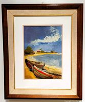 Frontal view of the framed oil painting depicting boats on seaside shore with vibrant colors and signed by artist.