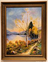 Framed oil painting depicting lakeside landscape with birch trees and path, showing painting and frame condition