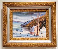 Front view of the framed oil painting showing winter landscape with houses and lake. Visible signature lower right.