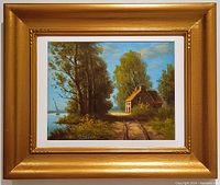 Frontal view of the painting with the gold painted wood frame showing overall condition and composition of the lakeside landscape scene.