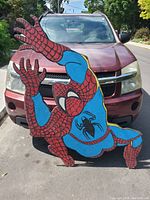 Front view of large Spider-Man cutout painting showing overall size and design