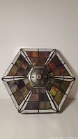 Top view showing the hexagonal shape with stained glass panels and metal center