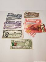 Overview of assorted Canadian Tire money bills arranged by denomination and color.
