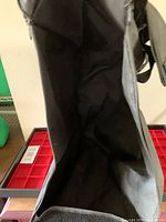 Open black fabric jewellery tote bag showing interior and red stacking trays.