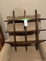 Front view of the dark brown wooden grid shelf showing nine compartments for display or storage.