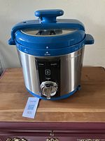 Closed view of Wolfgang Puck pressure cooker showing control dial and locking lid