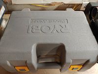 Closed hard plastic carrying case embossed with 'Ryobi Biscuit Jointer'