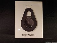 Front view of the Igloohome Smart Keybox 3 in box packaging showing the keypad lock.
