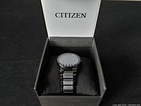 Citizen Eco-Drive men's wristwatch presented in its original branded box on black cushion.