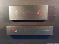 Closed black boxes with Tuo logos and Japanese-style text on top, showing packaging