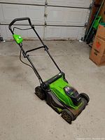 Greenworks push lawn mower in garage