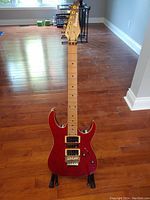 Full-length front view of red Ibanez EX3700 guitar showing body, neck, headstock