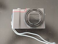 Front view of Panasonic Lumix DMC-ZS100 camera body with Leica lens extended