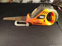 Side view of the power handsaw showing blade and handle.