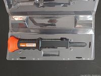 Photo front side of Ramset nailer tool in plastic tray showing model and warning labels.