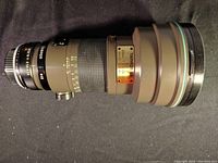 Side view of Tamron SP 300mm f/2.8 lens with hood extended