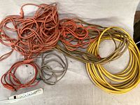 Full lot of extension cords and surge protector displayed together showing color and coil sizes