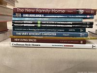 Spine view of 9 books including The New Family Home and Craftsman-Style Houses