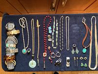 Overview of entire jewelry assortment laid out on dark cloth