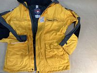 Jeantex T3000 yellow waterproof jacket front view showing sleeves, pockets, and front zipper