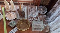 Various glass trays, bowls, coin banks, Noritake serveware pieces, horse bookends (one loose head), and wooden pig pen holder