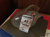 Clear view of the Orrefors bird vase showing its shape and transparency with MaxSold tag.