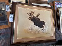 Full view of framed moose painting showing size and framing details.