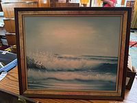 Framed ocean wave painting on canvas signed by R. Fisher with wood frame