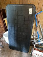 Top view of the black plastic top work table showing the grid texture surface and rounded corners.