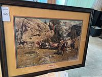 Full view of the framed art print showing a western scene with covered wagons in a mountain pass.