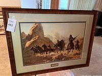 Full view of framed print featuring a Western scene with a stagecoach and riders, showing the frame and matting