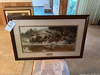 Framed print displayed in a living room, showing the full artwork and frame.