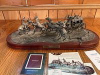 Full view of pewter diorama on base with brochures and certificate.