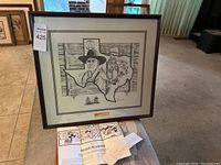 Full view of the framed lithograph print with matting showing cowboy portraits within the Texas state outline.