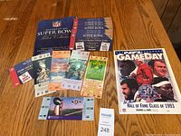 Photo showing Super Bowl ticket collection booklet, 7 replica Super Bowl tickets, and signed NFL Game Day Hall of Fame program