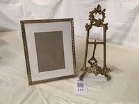 Photo showing the easel and 8x10 brass frame together from front angle.