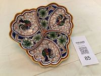 Front view of vintage tri-compartment ceramic plate with hand-painted roosters and colorful decorative motifs, scalloped edges.