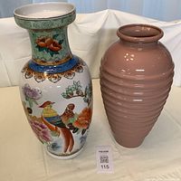 Photo showing two large vases, left is Chinese floral and bird motif porcelain vase, right is mauve ribbed vase.