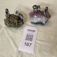 Photo showing both miner figurines with mules on mineral bases with MaxSold tag for lot 167