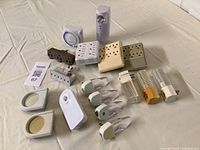 Boxed lot contents including night lights, outlet extenders, Garrison emergency light, timer