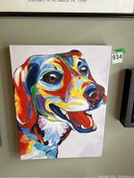 Front view of colorful abstract dog head painting on stretched canvas, showing full artwork and small green lot tag.