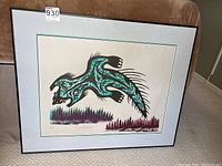 Framed limited edition indigenous art print with teal, black, purple, and white design. Signed and numbered in pencil at bottom.