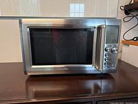 Front view showing stainless steel door, window, handle and control panel