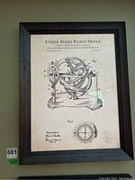 Framed patent print with black composite frame showing entire artwork and frame.